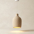 A pendant light unit with a design inspired by traditional pots and jars, featuring a rough texture and warm earthy color to distribute soft light that adds authenticity and simplicity to the architectural space.