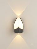 A modern wall lamp (sconcealer) with a design that combines sharp metal lines and soft curves, distributing symmetrical light up and down to form an attractive light pattern on the wall.