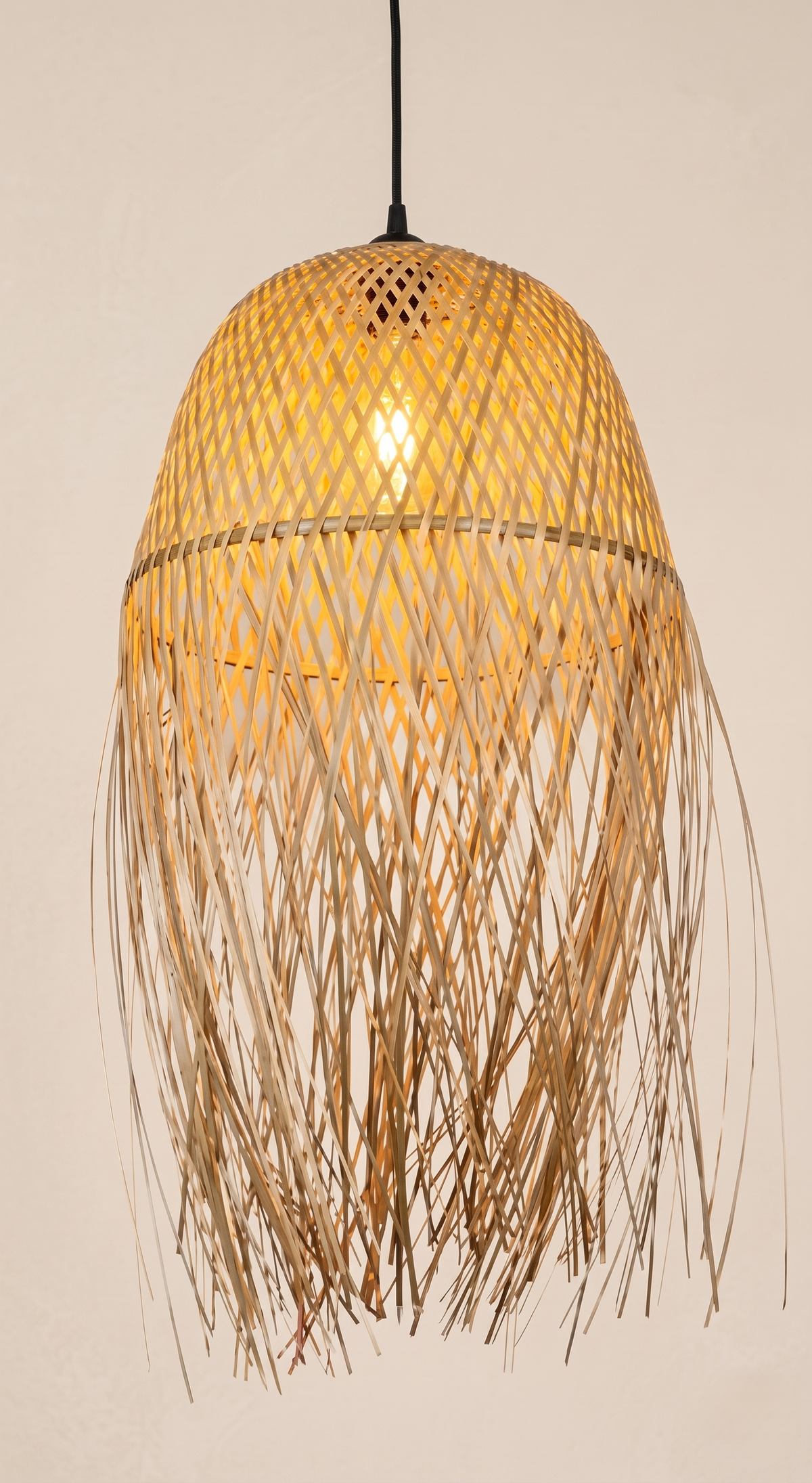 A pendant light unit made from hand-woven bamboo with a streamlined, organic design.