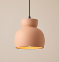A pendant light unit with a contemporary design that mimics traditional pottery, with a warm, earthy touch that adds authenticity and tranquility to the architectural space.