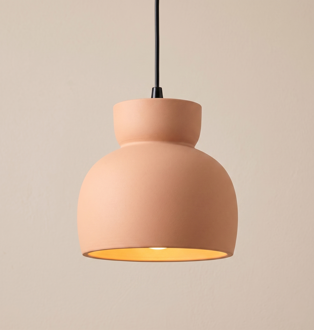 A pendant light unit with a contemporary design that mimics traditional pottery, with a warm, earthy touch that adds authenticity and tranquility to the architectural space.