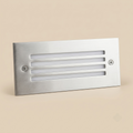 Flush-mount stainless steel step light with slotted grille