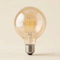 Vintage Edison filament globe bulb with amber glass